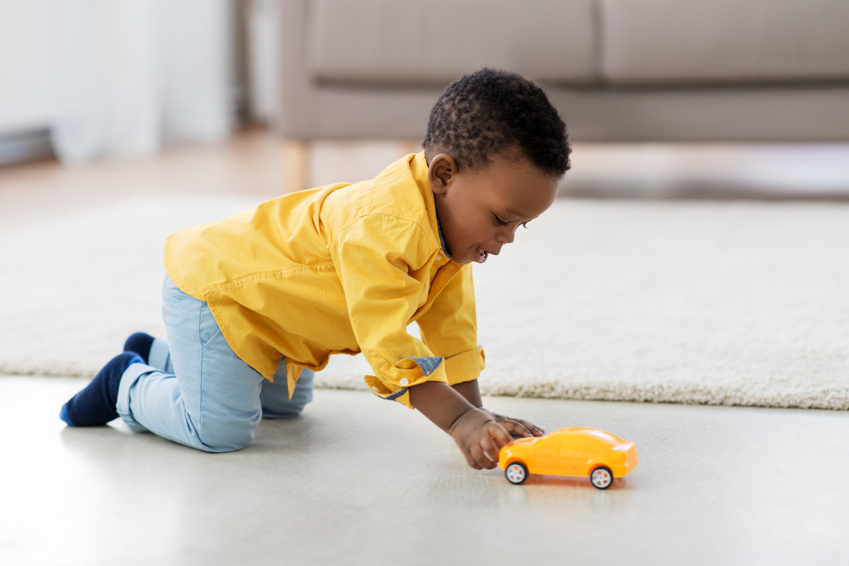 Boy Playing with Toy Car